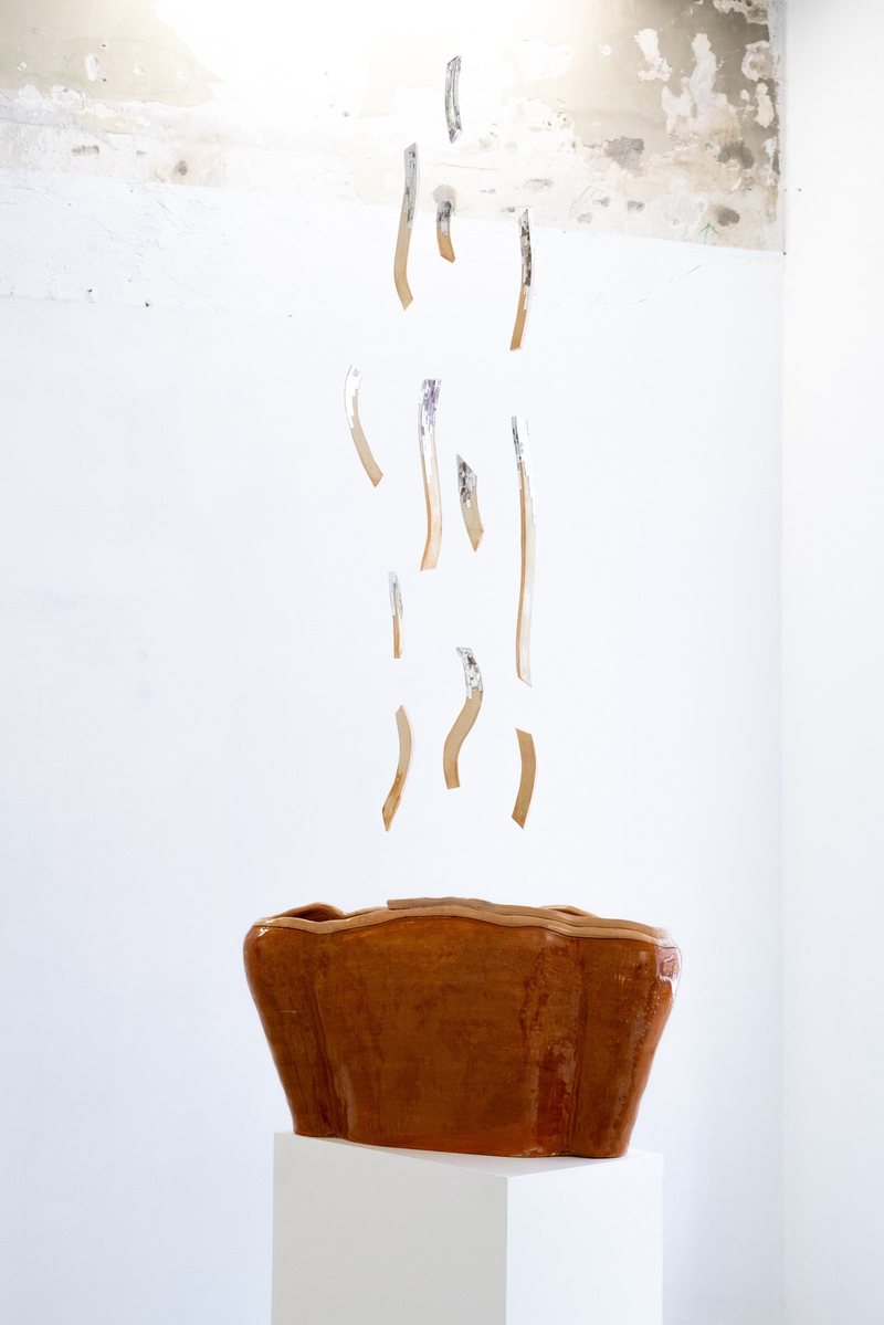 Ember, 2026. Ceramic torso on a plinth with suspended ceramic pieces carrying hand-cut mirror