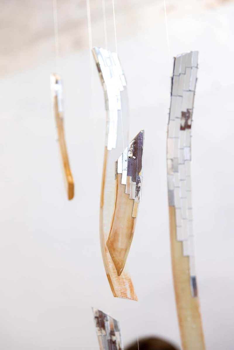 Ember (2026), ceramic torso on a plinth with suspended ceramic pieces carrying hand-cut mirror, view 2